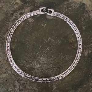 Metal choker 14 3/4 inches.  Does not tarnish.